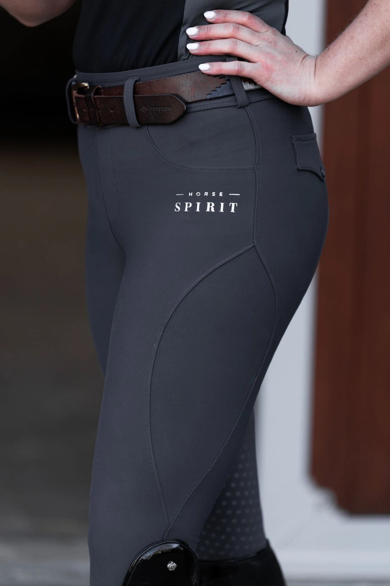 Close-up of the Horse Spirit logo printed on the grey riding leggings.
