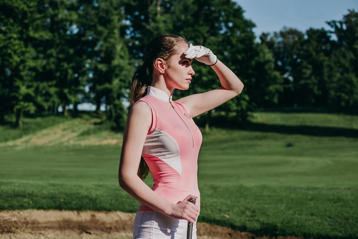 Horse Spirit Riding Top in action - Golf player in pink and white top showcasing freedom of movement and elegant style.