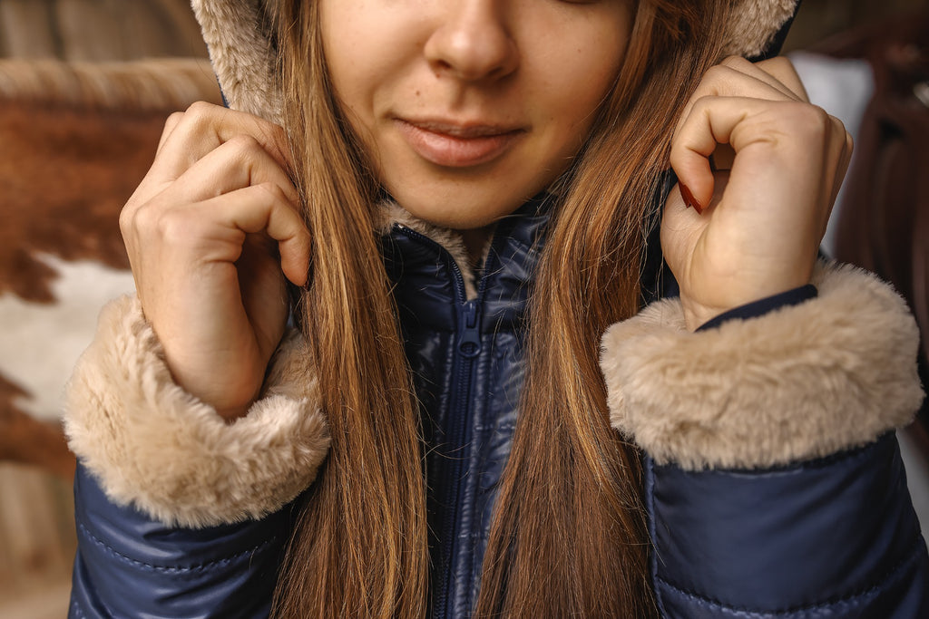 Close-up detail of the Horse Spirit Riding Winter Jacket - Elegant fur trim and water-resistant technical fabric on blue winter jacket.