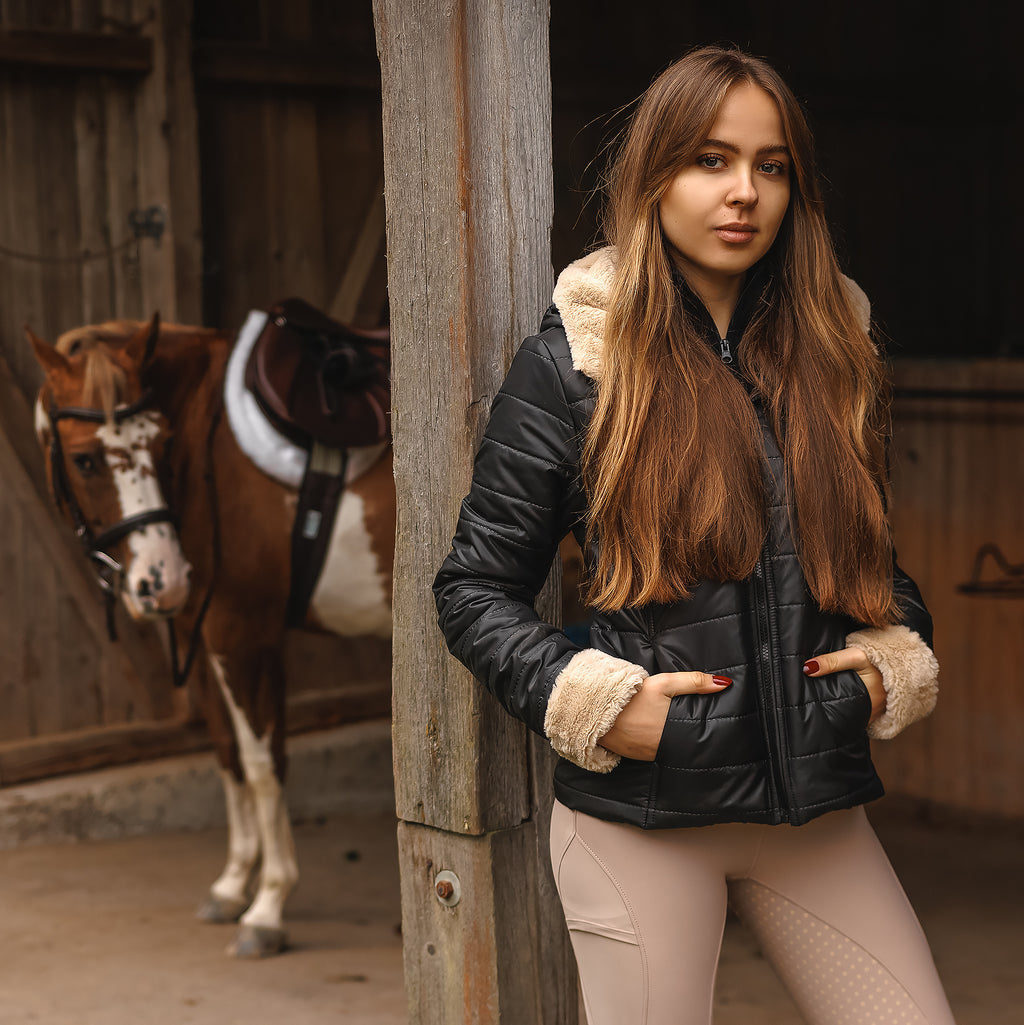 Horse Spirit Riding Winter Jacket in action - Equestrian rider in black winter jacket with fur trims, showcasing weather protection and elegant style in cold conditions.