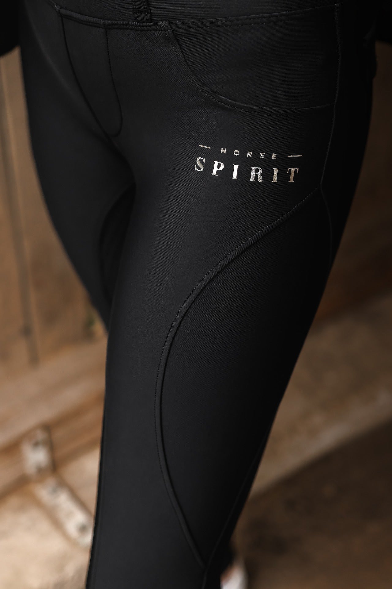 Horse Spirit Winter Riding Leggings in black - Front view on model showing silicone grips, higher waist, thigh phone pocket, and insulating winter fabric for cold-weather riding.
