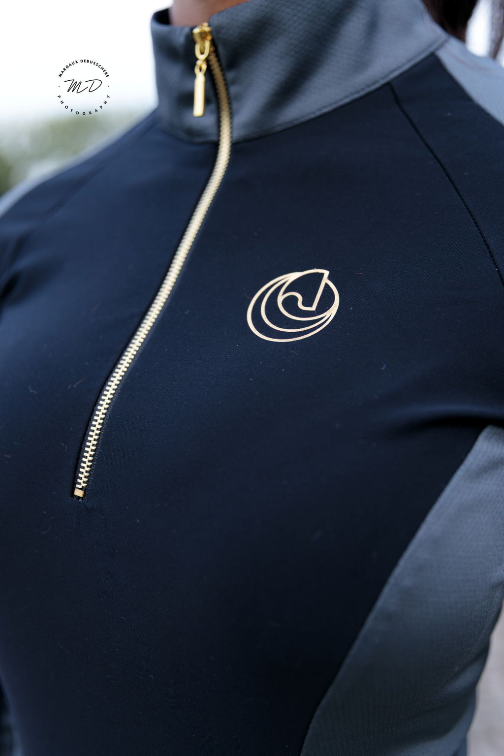 Close-up detail of the Horse Spirit Riding Layer - Iconic Horse Spirit logo and  grey brushed thermal fabric.