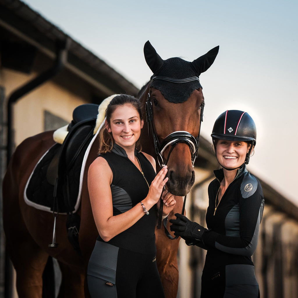 Horse Spirit Riding Top in action - Equestrian rider in black and grey top showcasing freedom of movement and modern style during training.