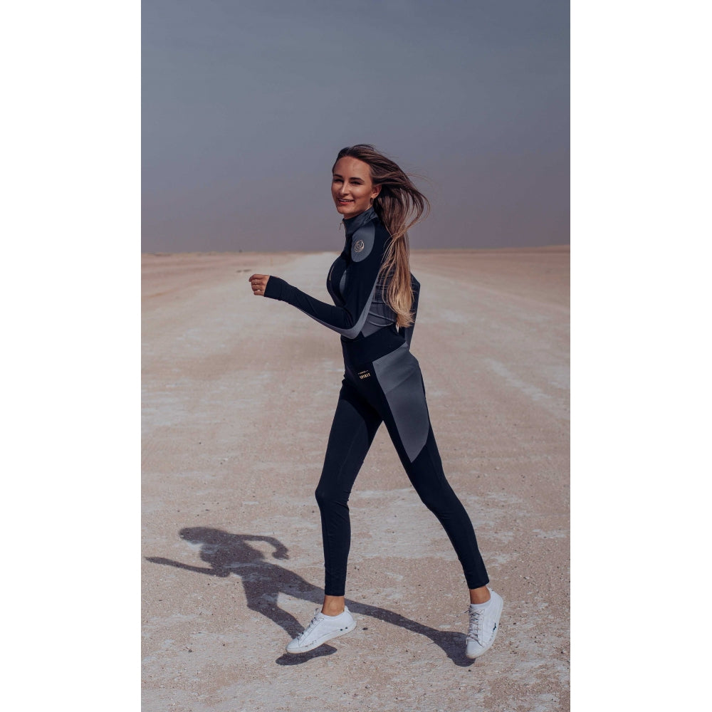 Horse Spirit Riding Layer in action - Rider in black and grey layer with hand covers showcasing performance fit and modern elegance during training.